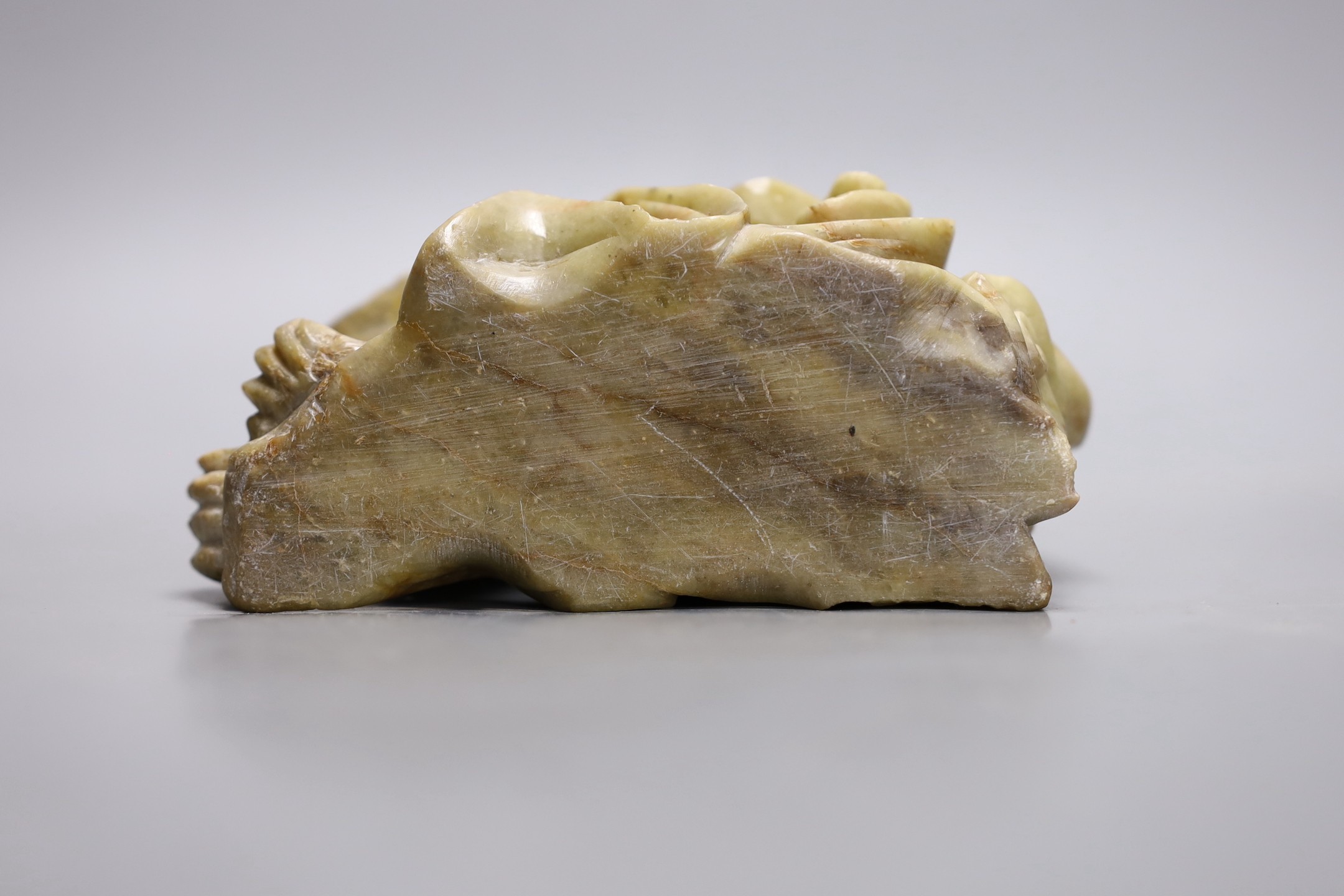 A Chinese soapstone group of a luohan riding a lion, 20cm